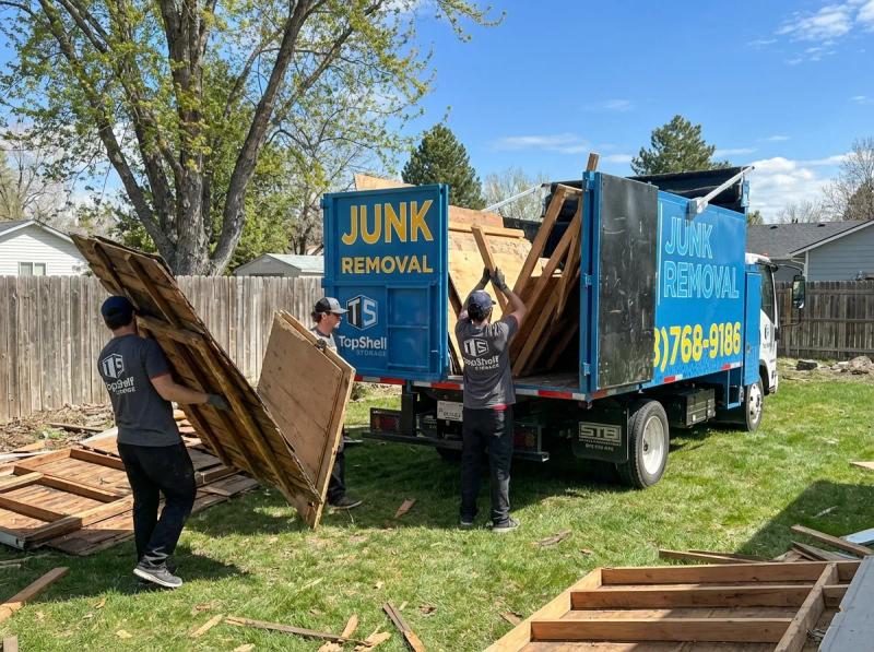 Top Shelf crew member using tools to dismantle an old shed in Middleton Idaho