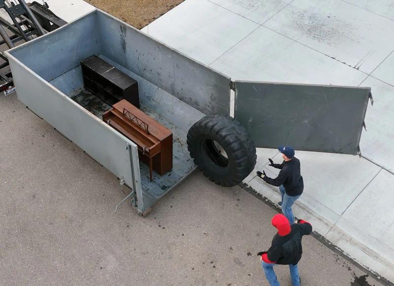 Aerial view of Top Shelf crew loading tires into the junk removal truck