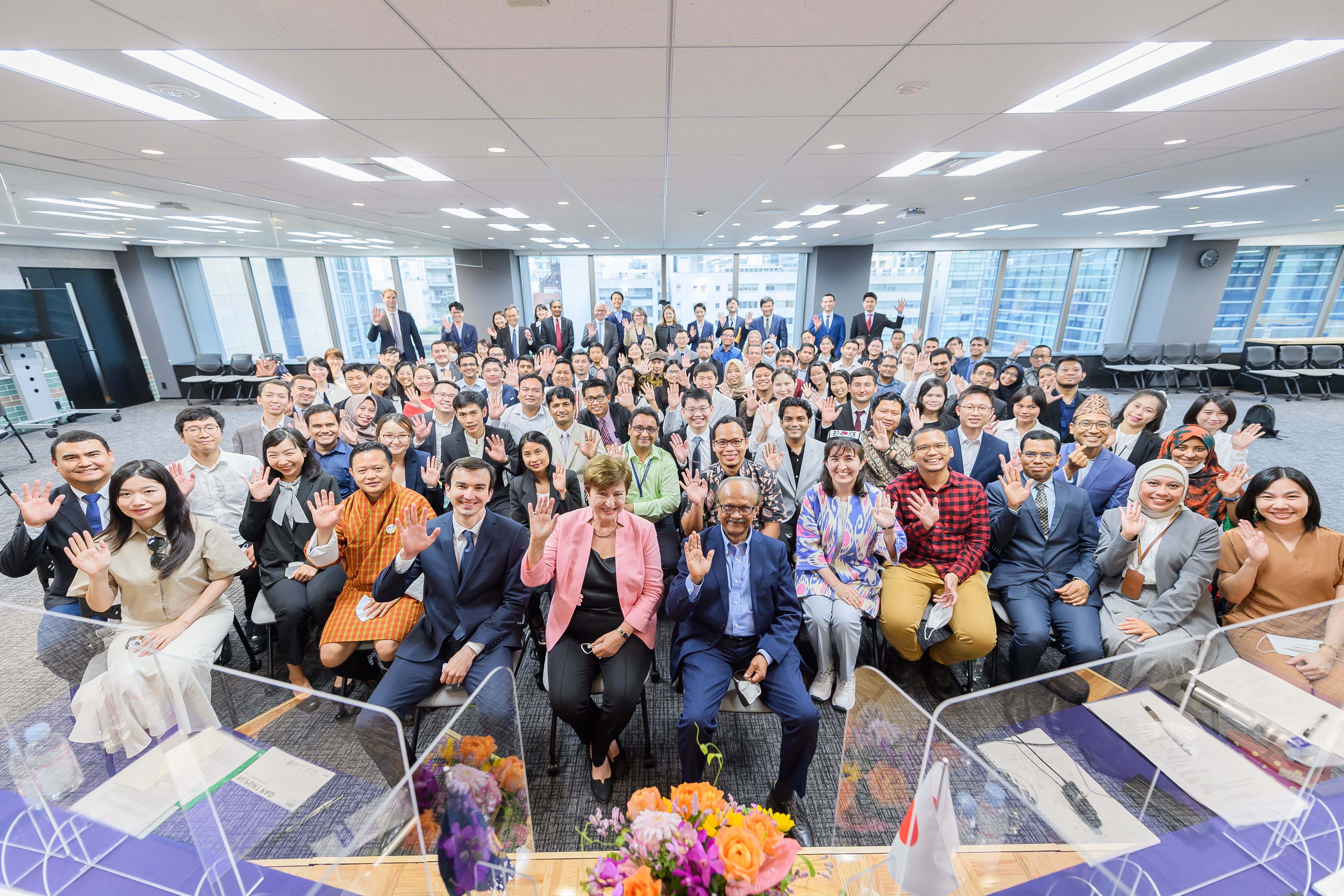 IMF staff smiling and waving to the camera