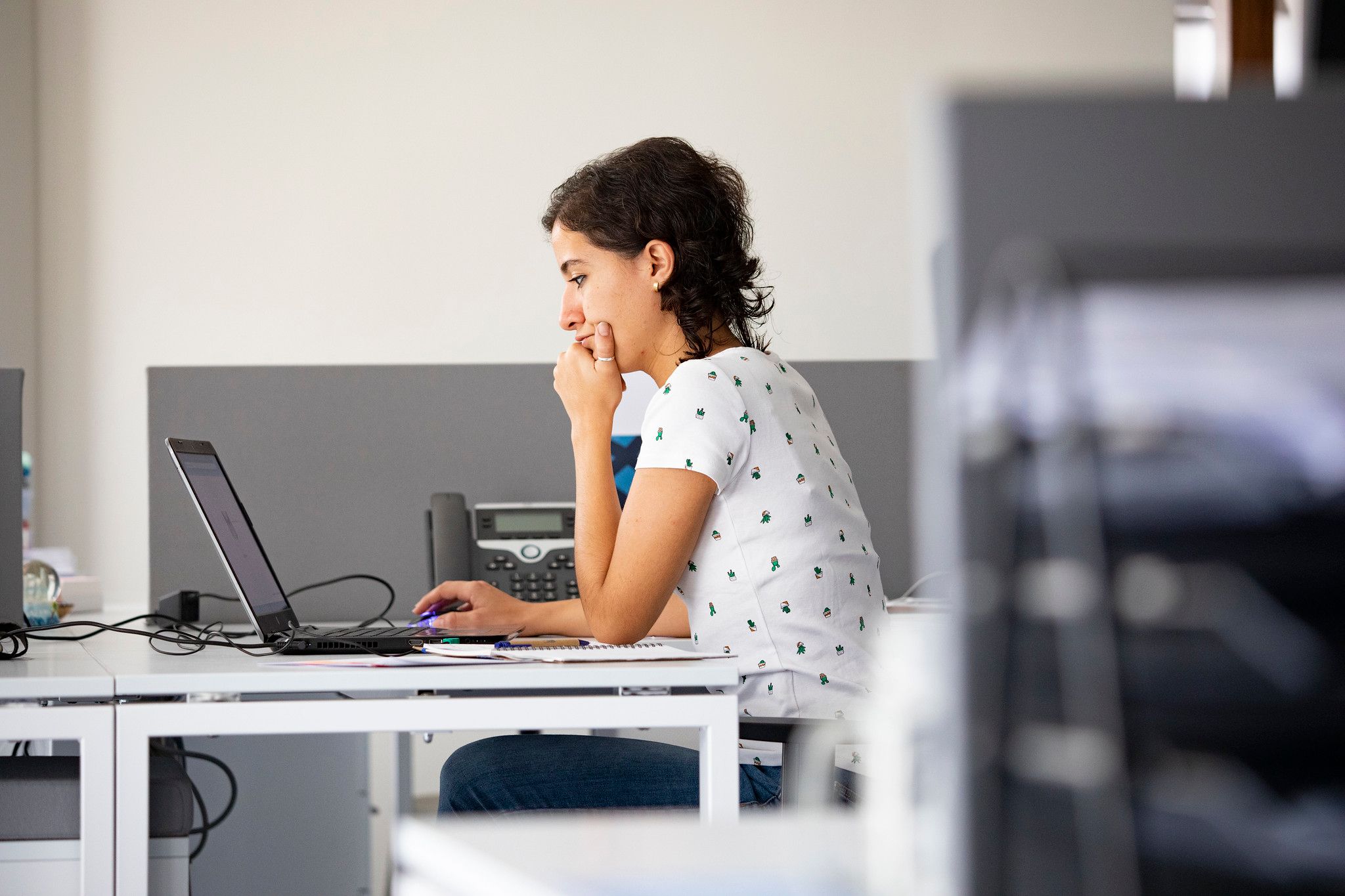 A woman works with a laptop in front of her