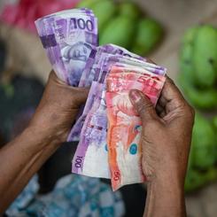 A fruit vendor counts her bills in Quiapo, Manila, Philippines, on March 10, 2021.