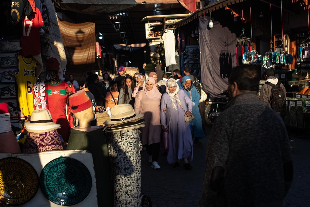 People walk in outside market in Morocco