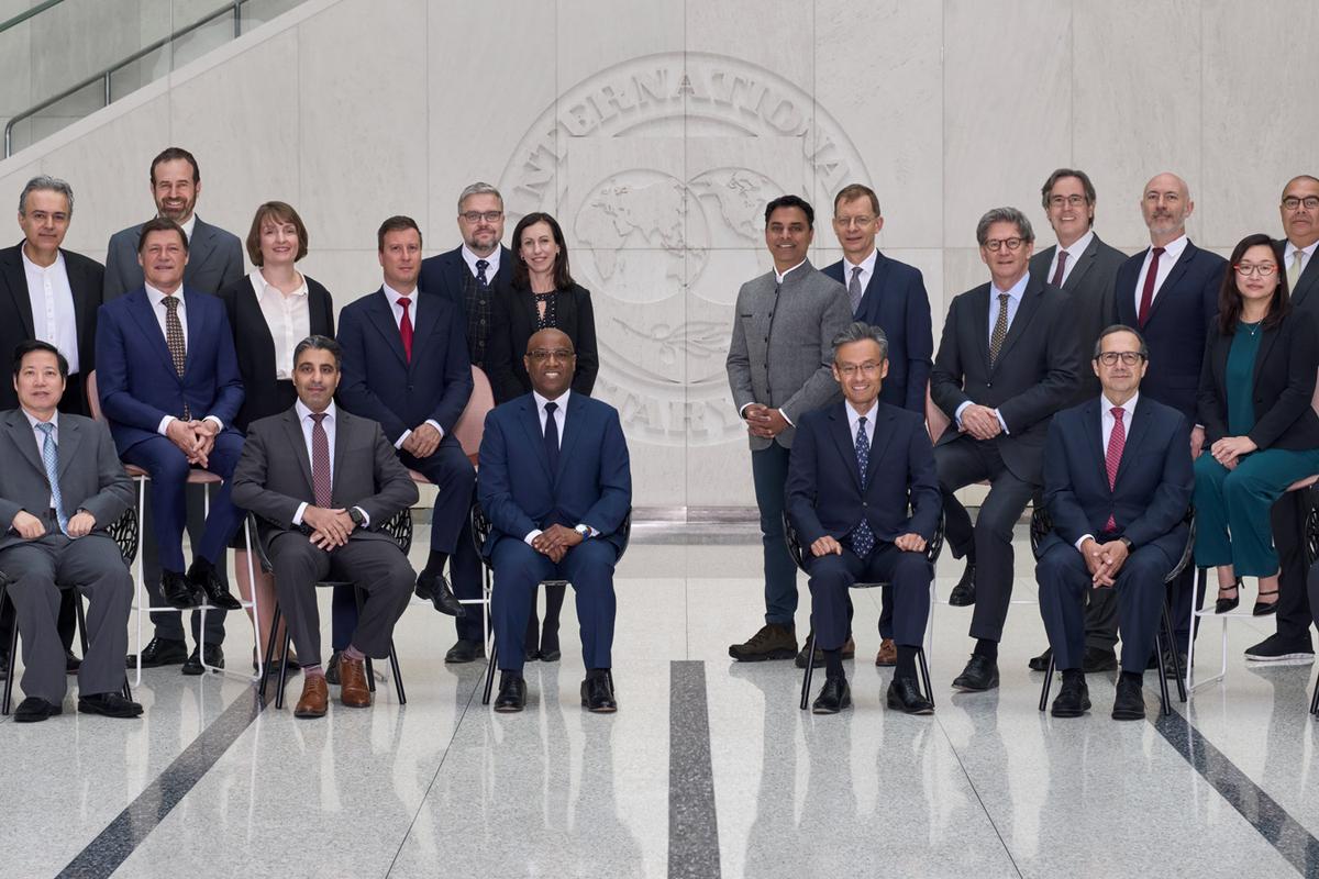 Executive directors gathered in a group photo inside of the IMF headquarters