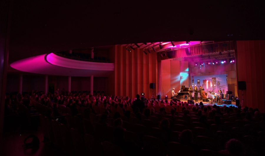 Wide view of a live performance and audience.