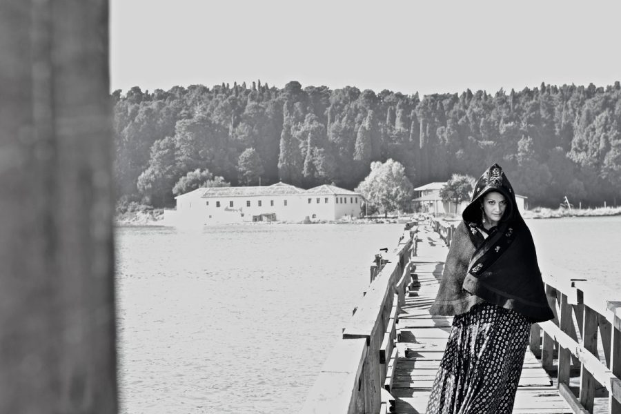 Entropy portrait on a wooden bridge in traditional clothing.