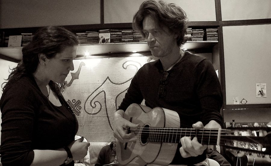 Black-and-white rehearsal photograph with guitarist