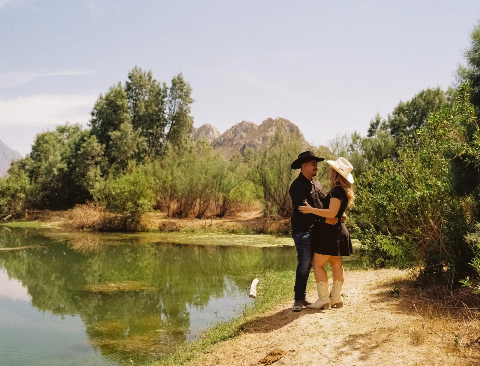 A western styled couple by the river and mountains of Mina