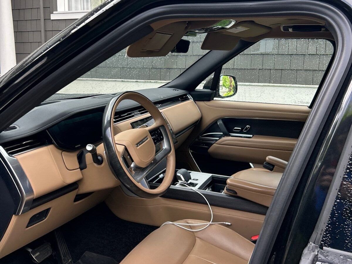 Tan leather dashboard and steering wheel inside a Range Rover