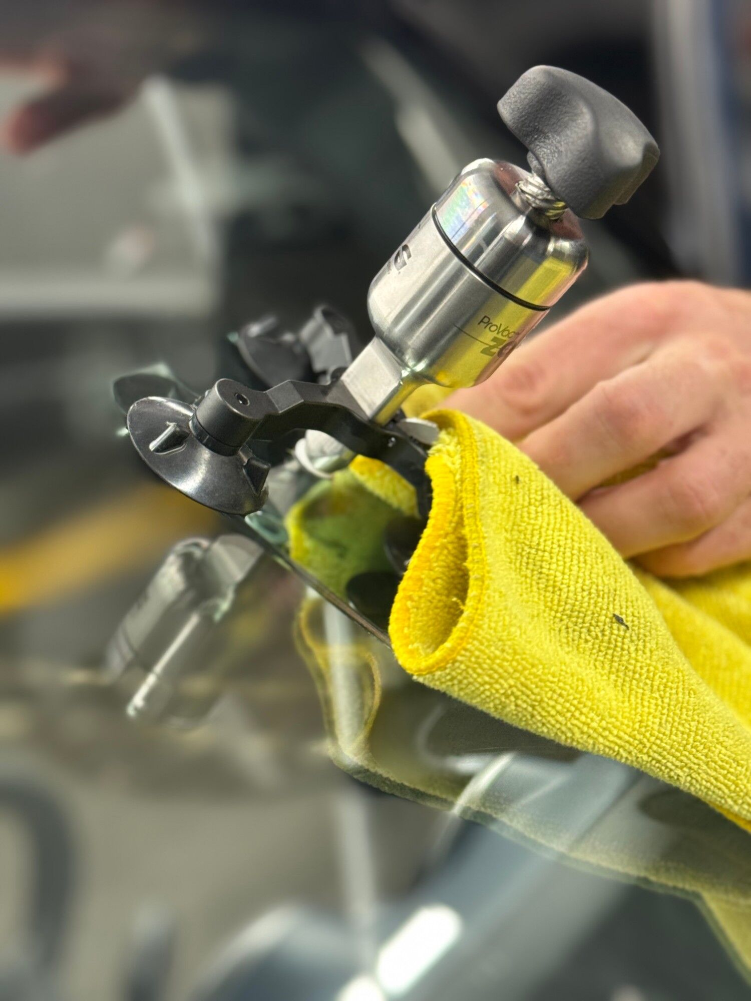 Windshield chip repair tool with a yellow microfiber towel
