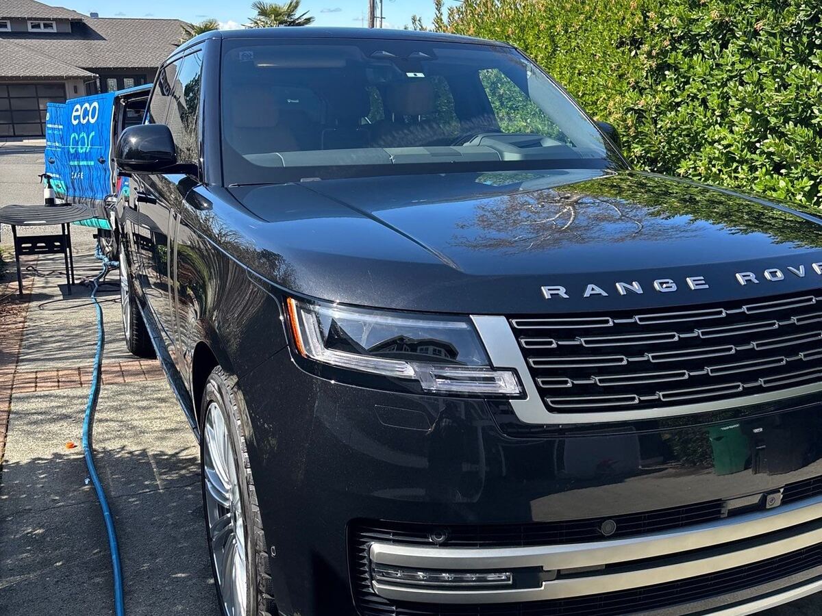 Black Range Rover front end after a detail, parked on a driveway