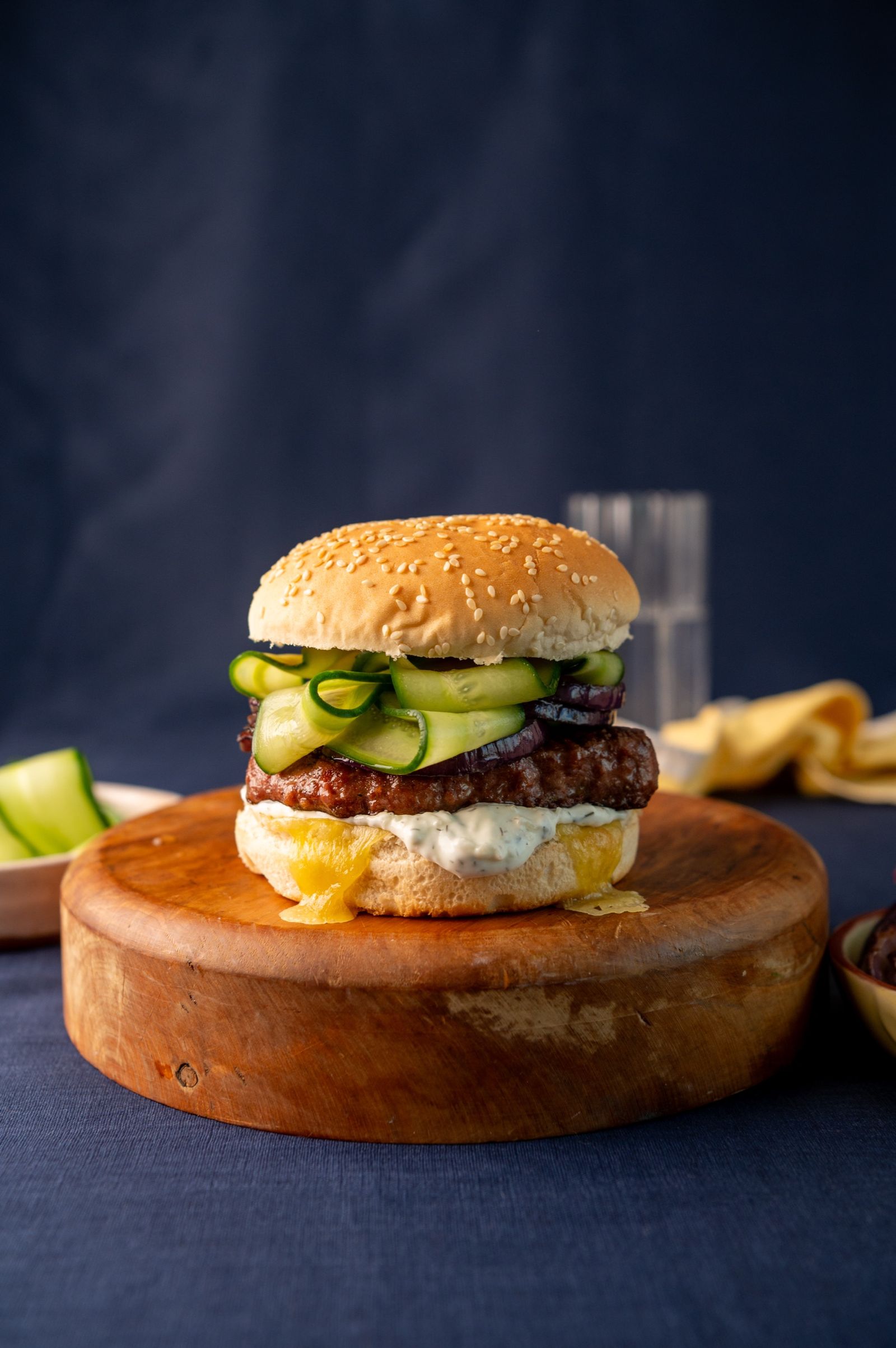 Lamb burger stacked with pickled cucumber