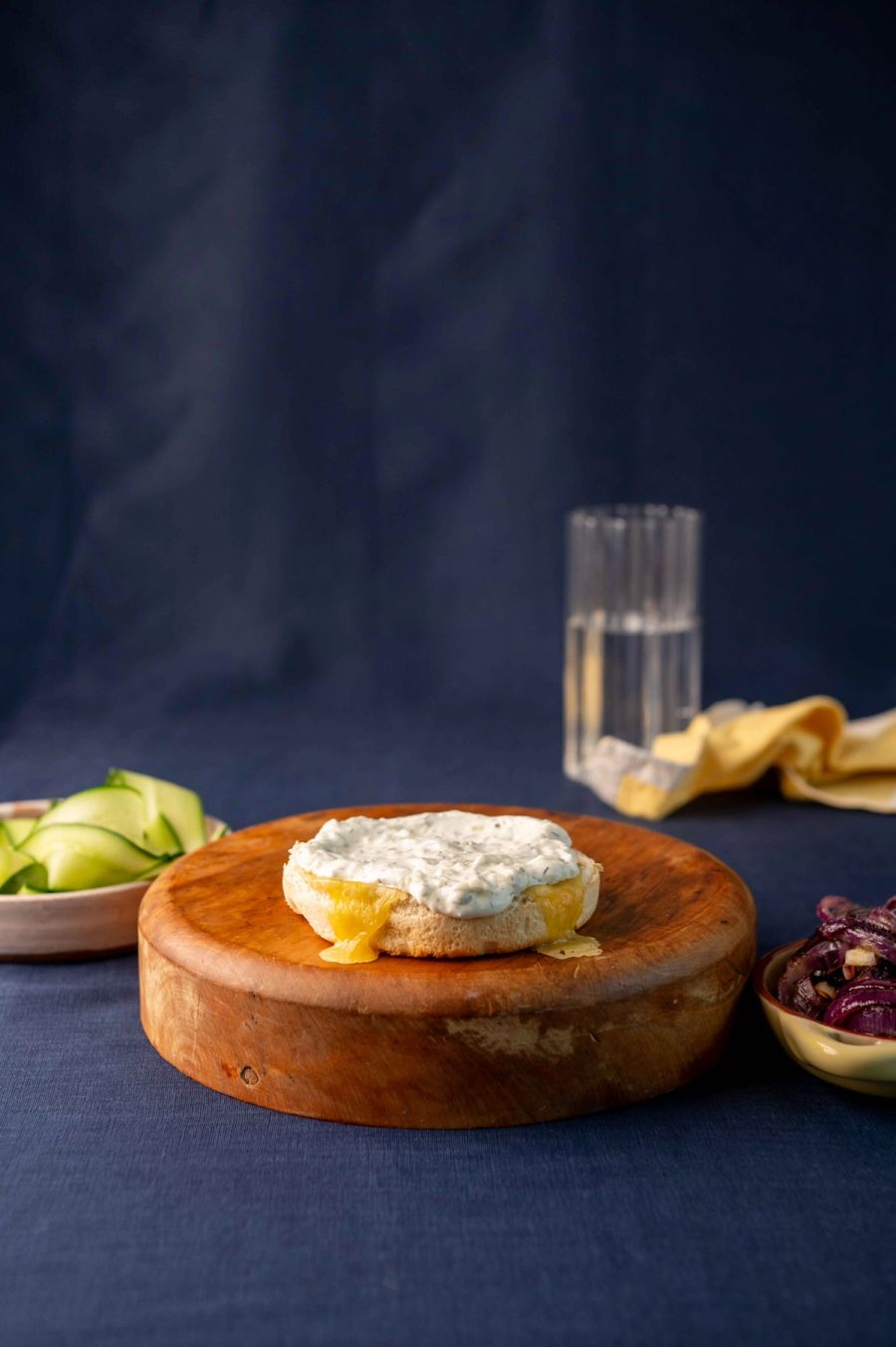 Tzatziki spread over the cheese