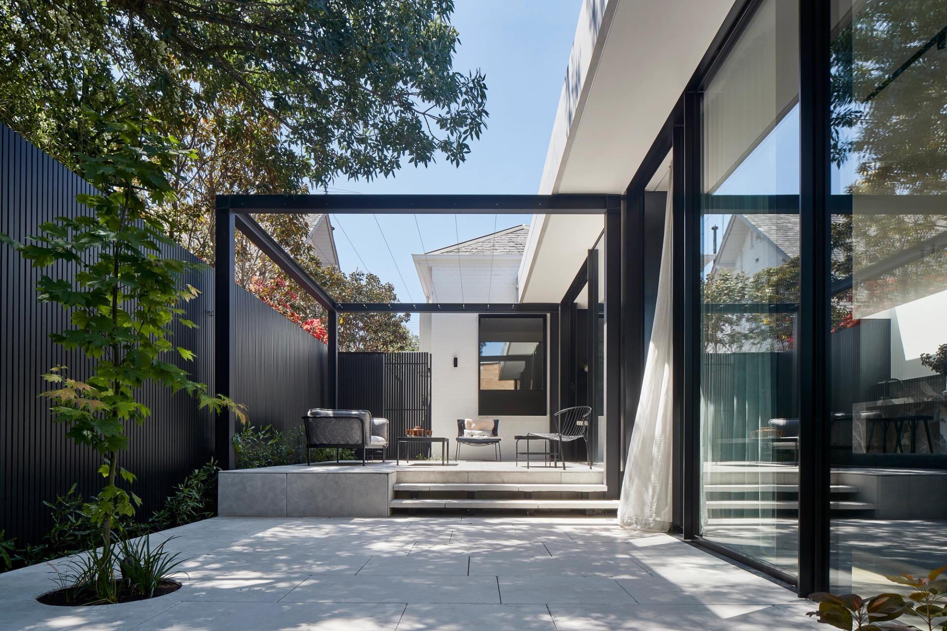 The sunny outdoor terrace connects to the open-plan living and dining area.