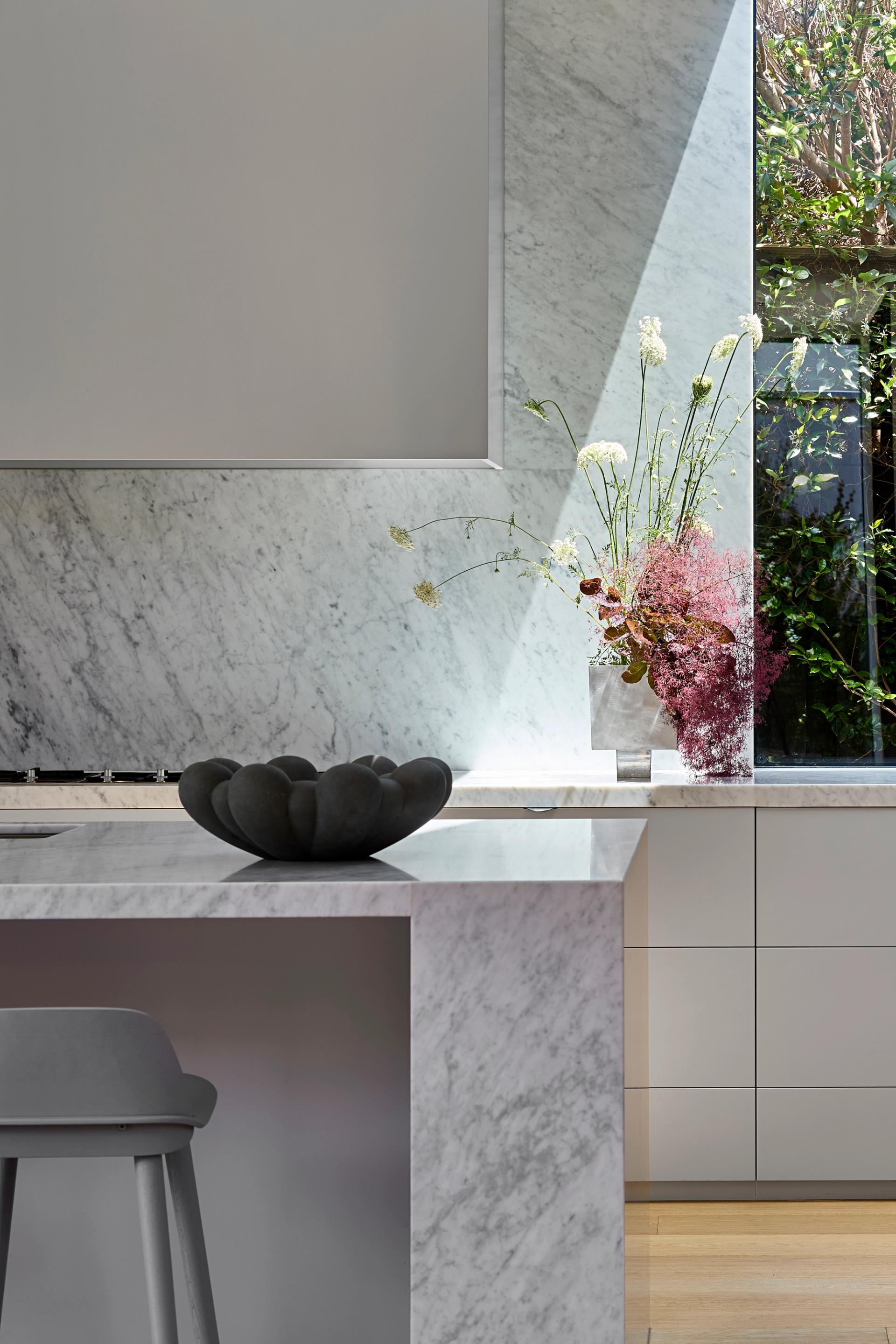 The linear skylight along the kitchen's back wall floods the space with natural light.