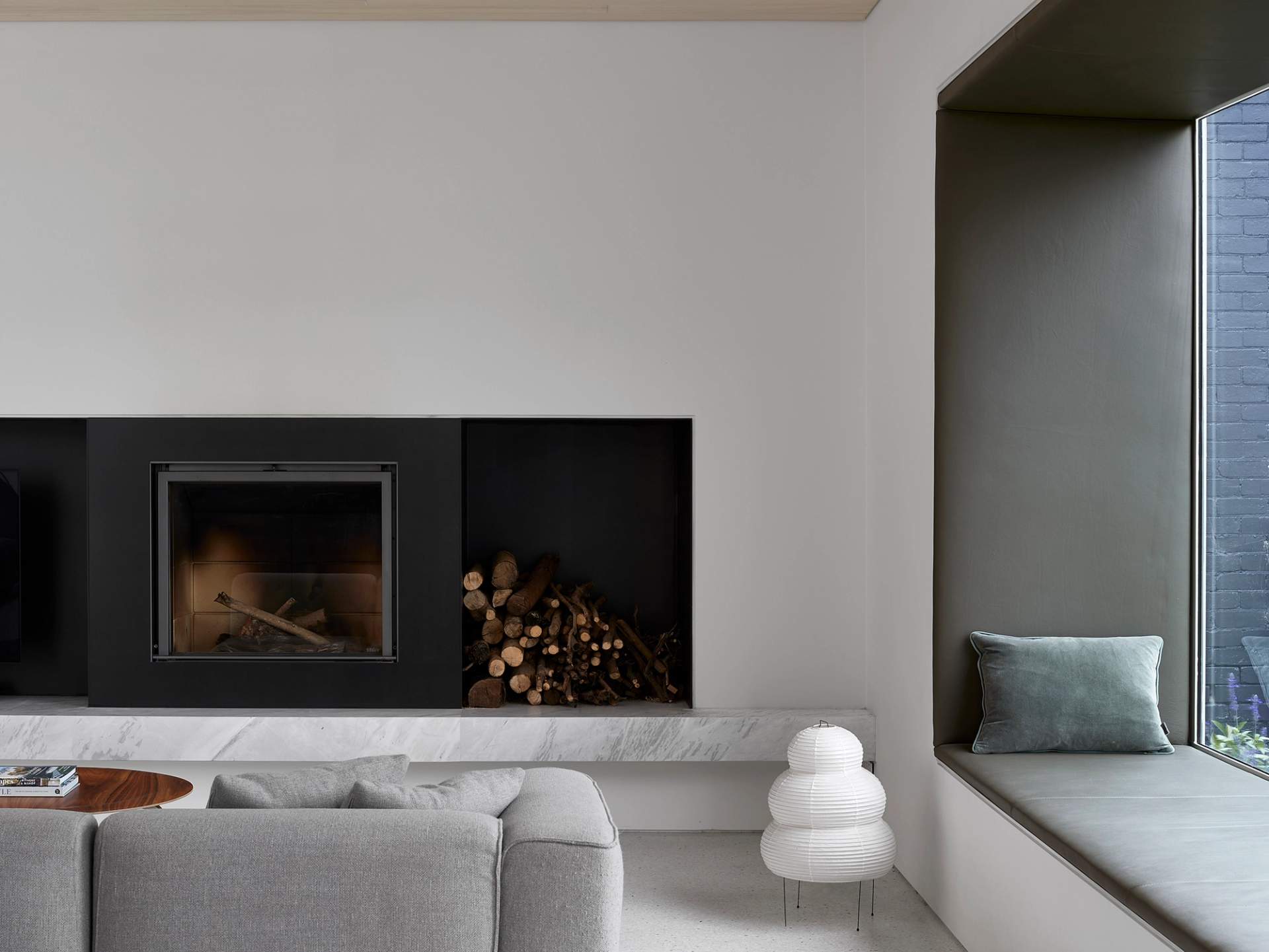 A cantilevered steel box frame window seat is a focus of the open-plan living area.