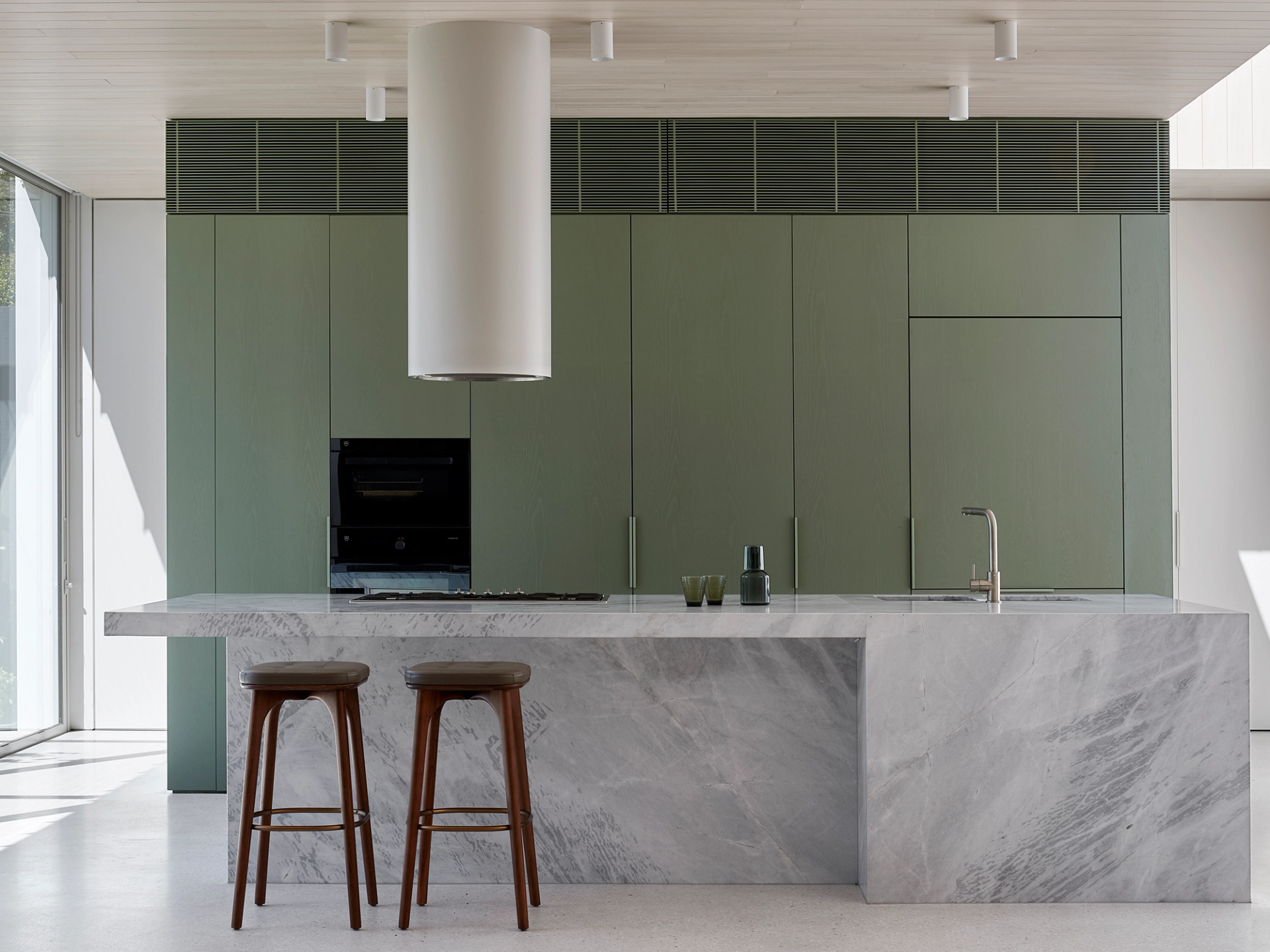 The Armadale home's kitchen conceals a versatile galley and offers views of the garden.