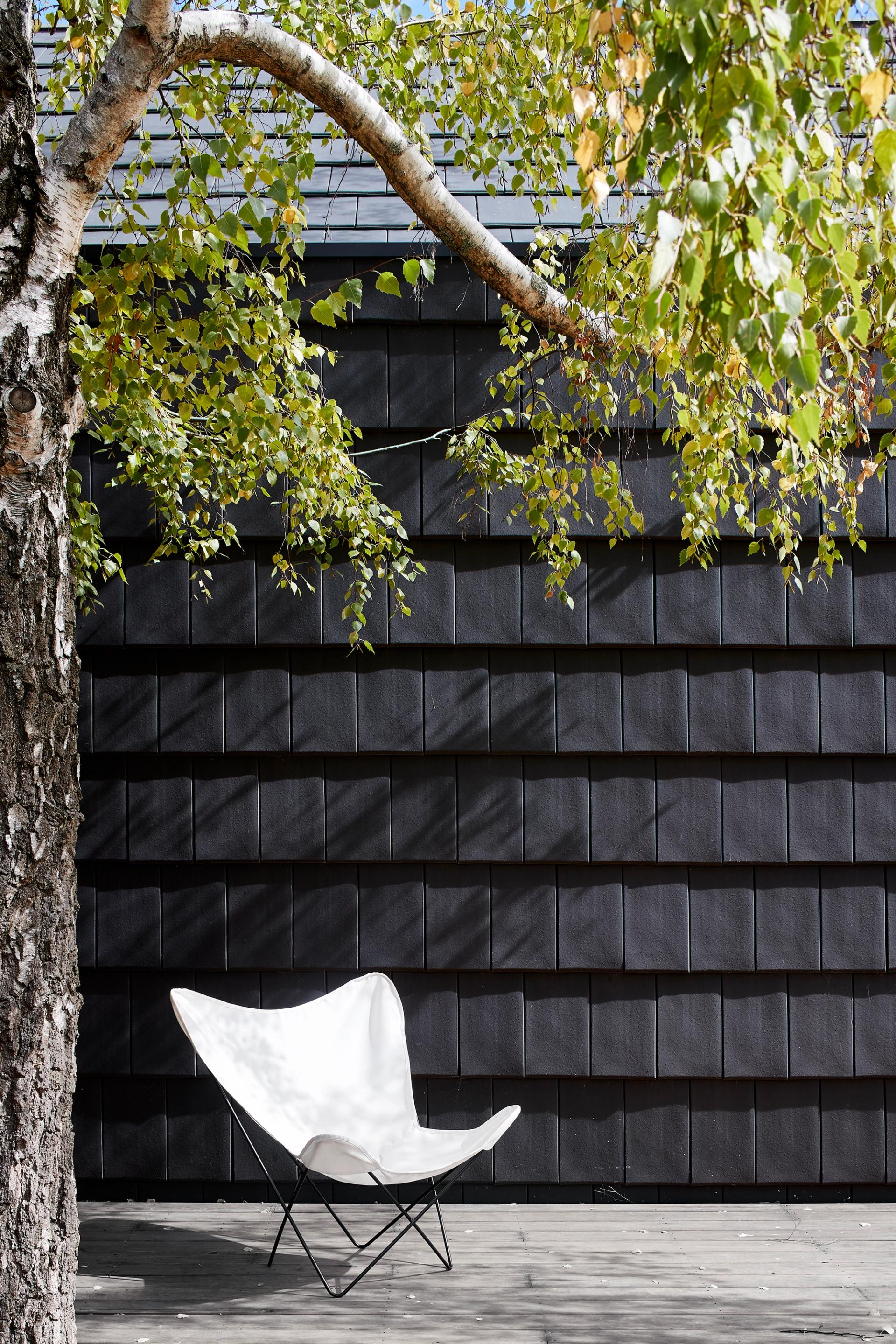 The exterior's timber and shingles adds texture and layers to separate the extension from the original weatherboard home.