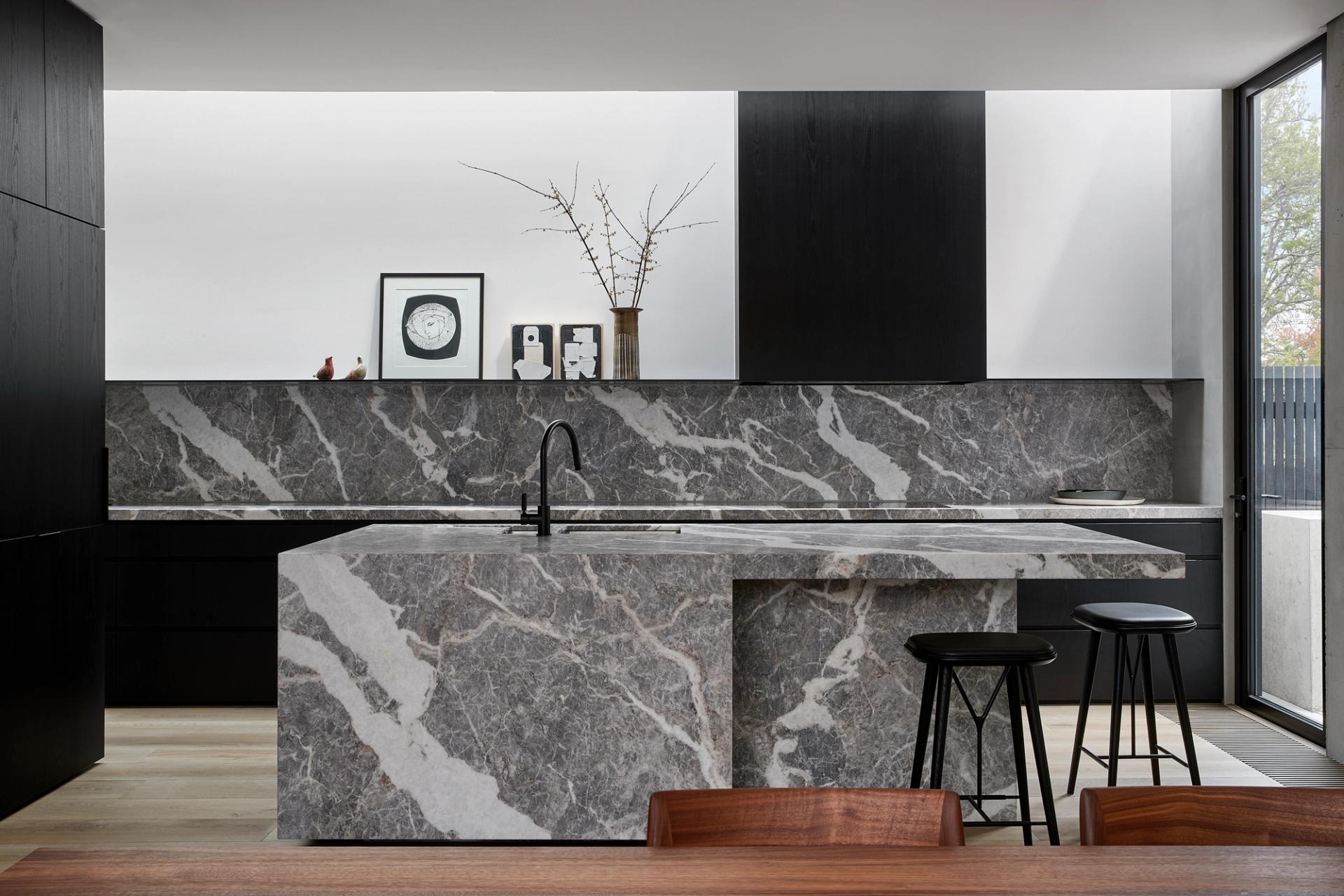 The stone kitchen and its sculptural stone bench are the heart of Hidden House.