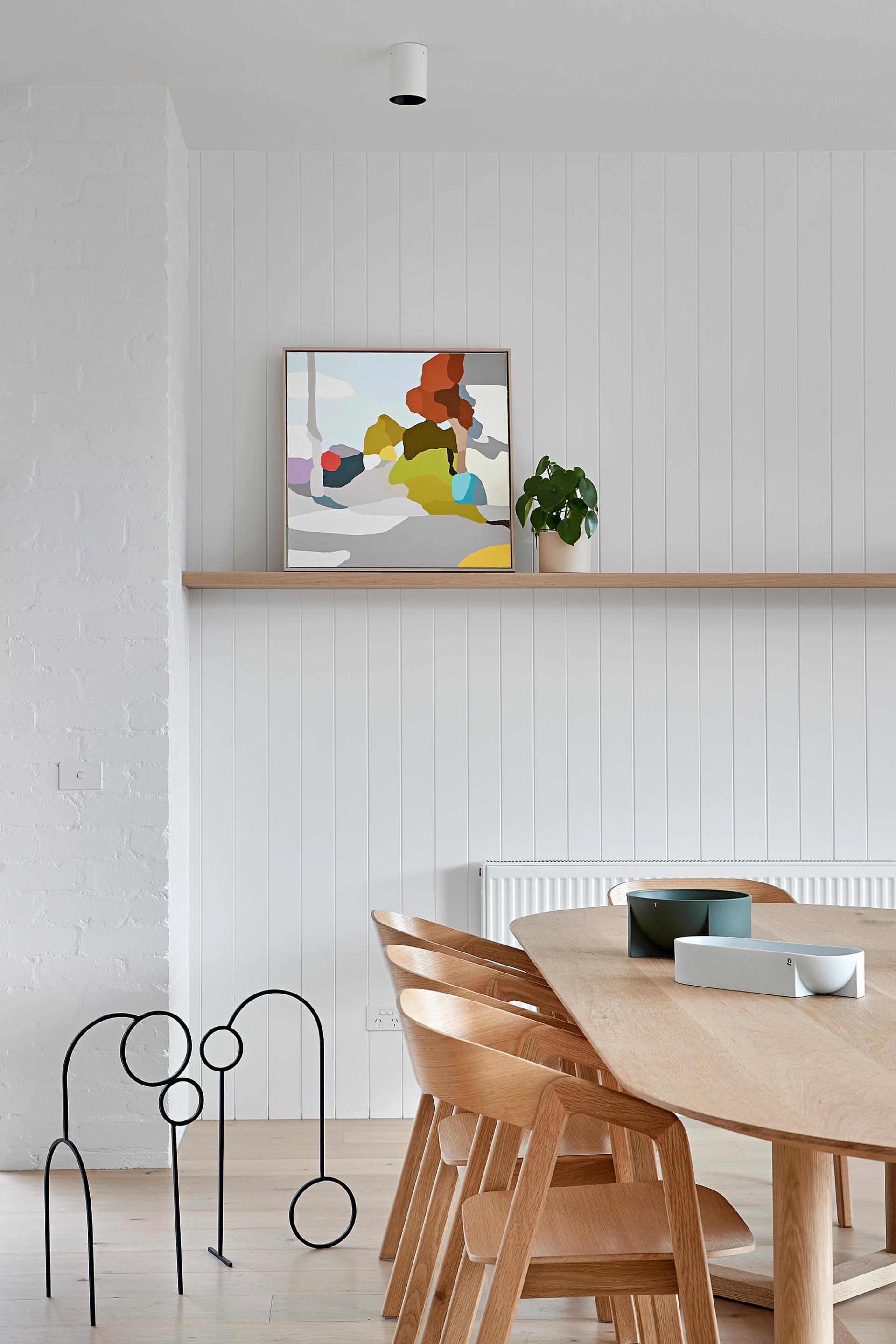 White bricks and limed timber linear wall panelling adds to the home's breezy atmosphere.