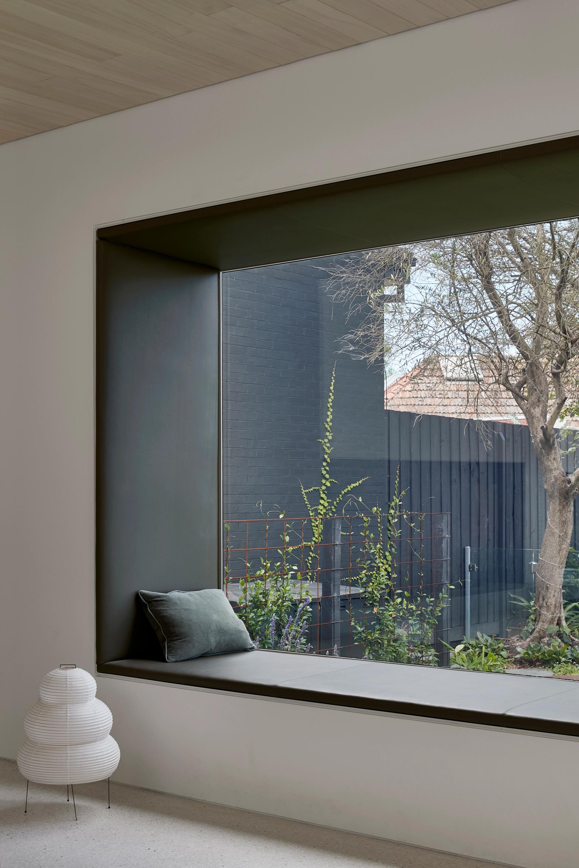 The wondow seat frames a view of the raised pool outside.