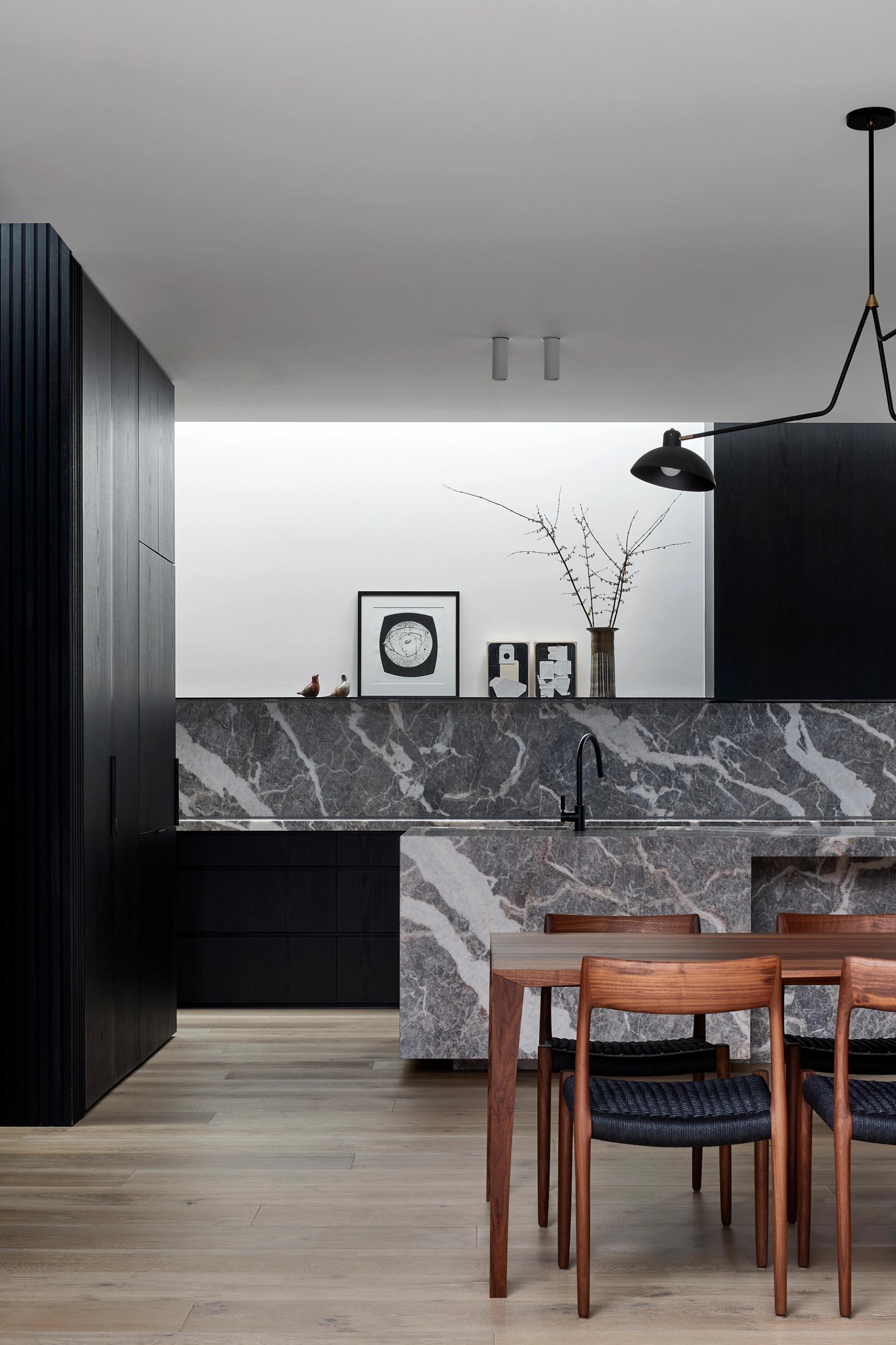 The stone kitchen and its sculptural stone bench are the heart of Hidden House.