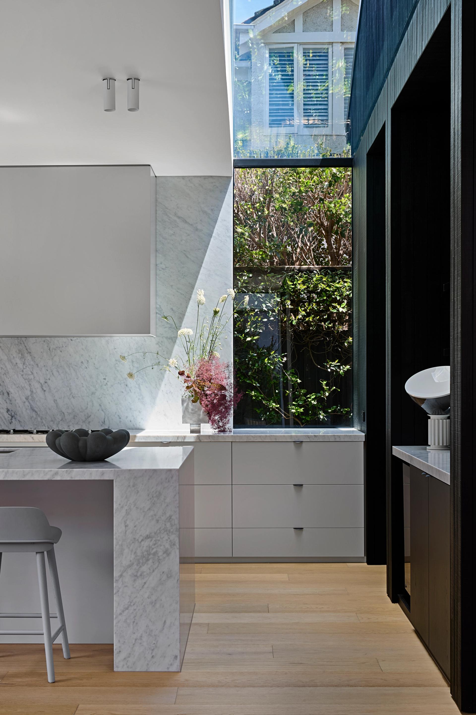 The linear skylight along the kitchen's back wall floods the space with natural light.