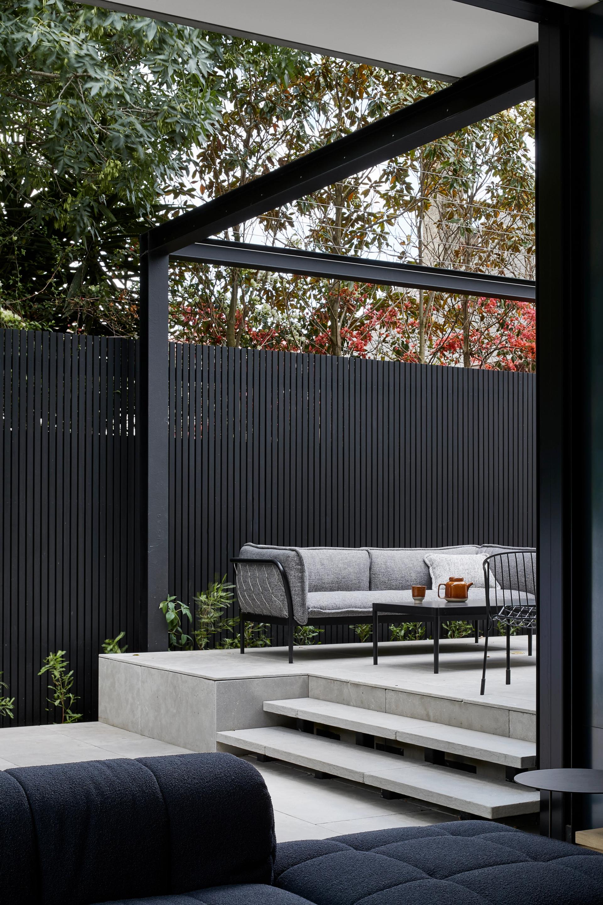 The concrete living pavilion extends the home's living areas to the outdoors.