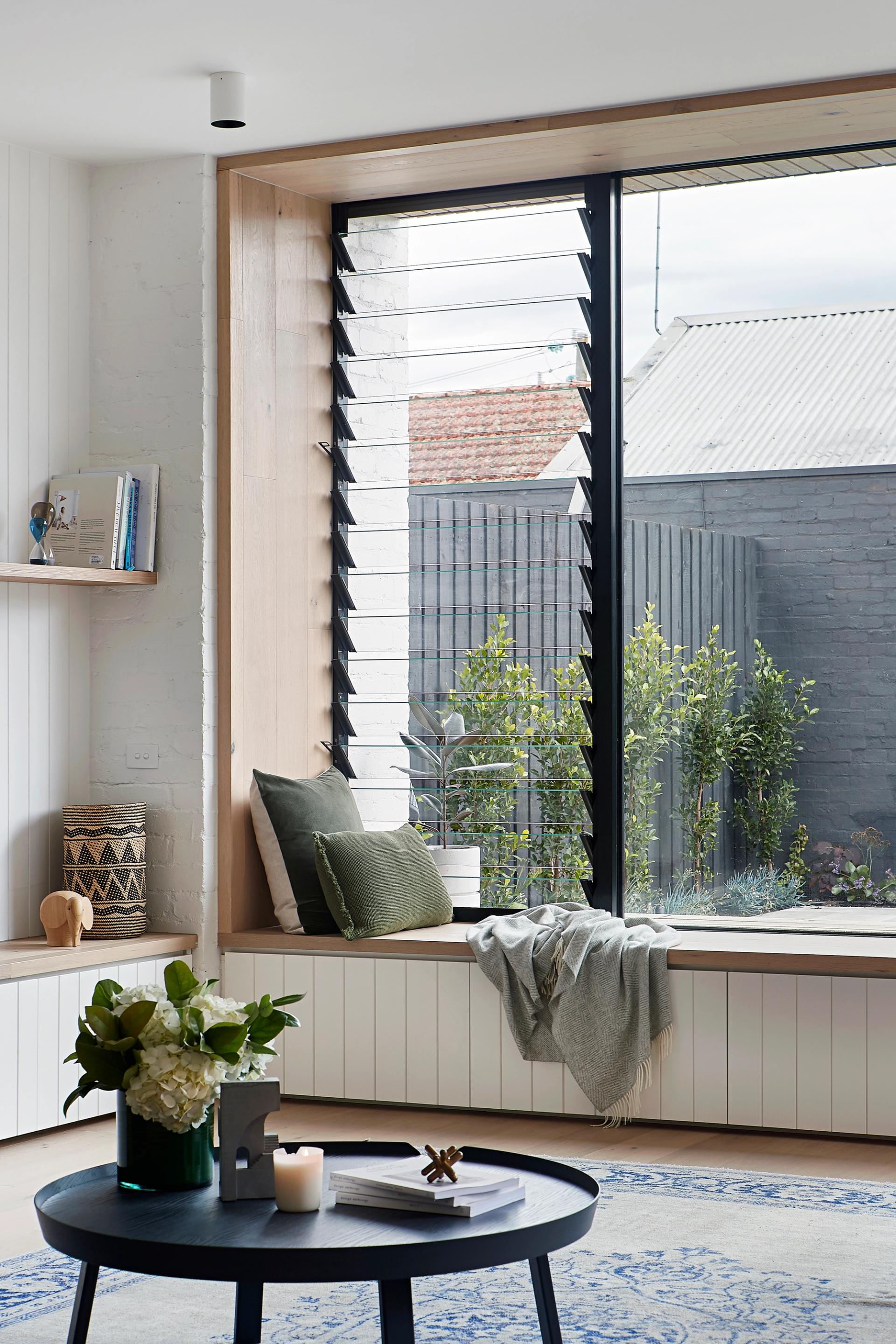 The living space features a large north-facing window seat that centres on the pool.