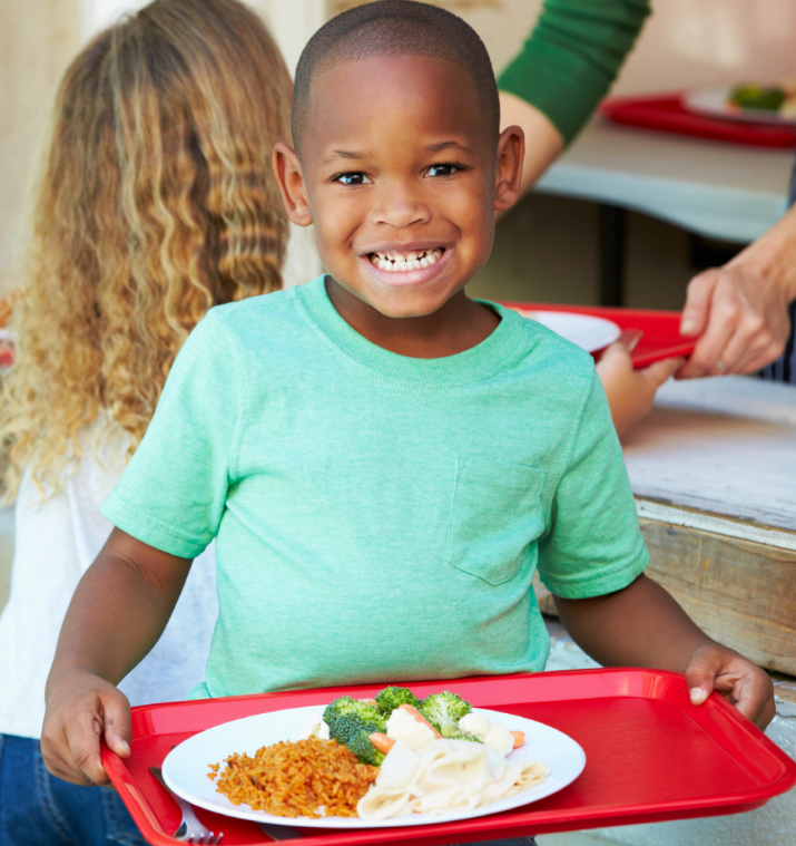 happy young child with lunch tray