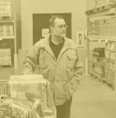 middle-aged man standing in a grocery store