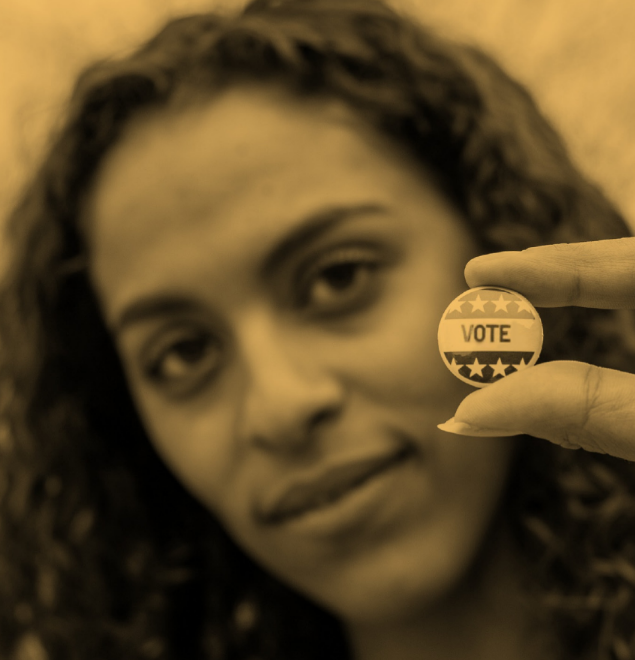 close up of person holding a "vote" button