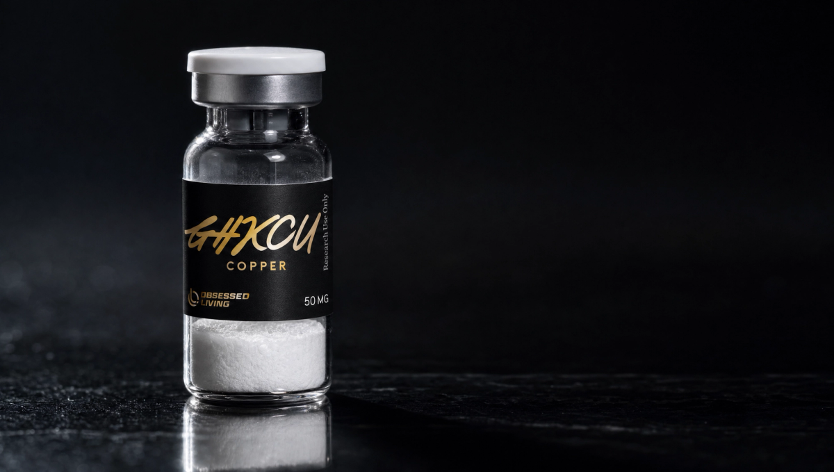 Research vial of GHK-Cu with the Obsessed Living label on a dark reflective surface — research-use-only laboratory aesthetic