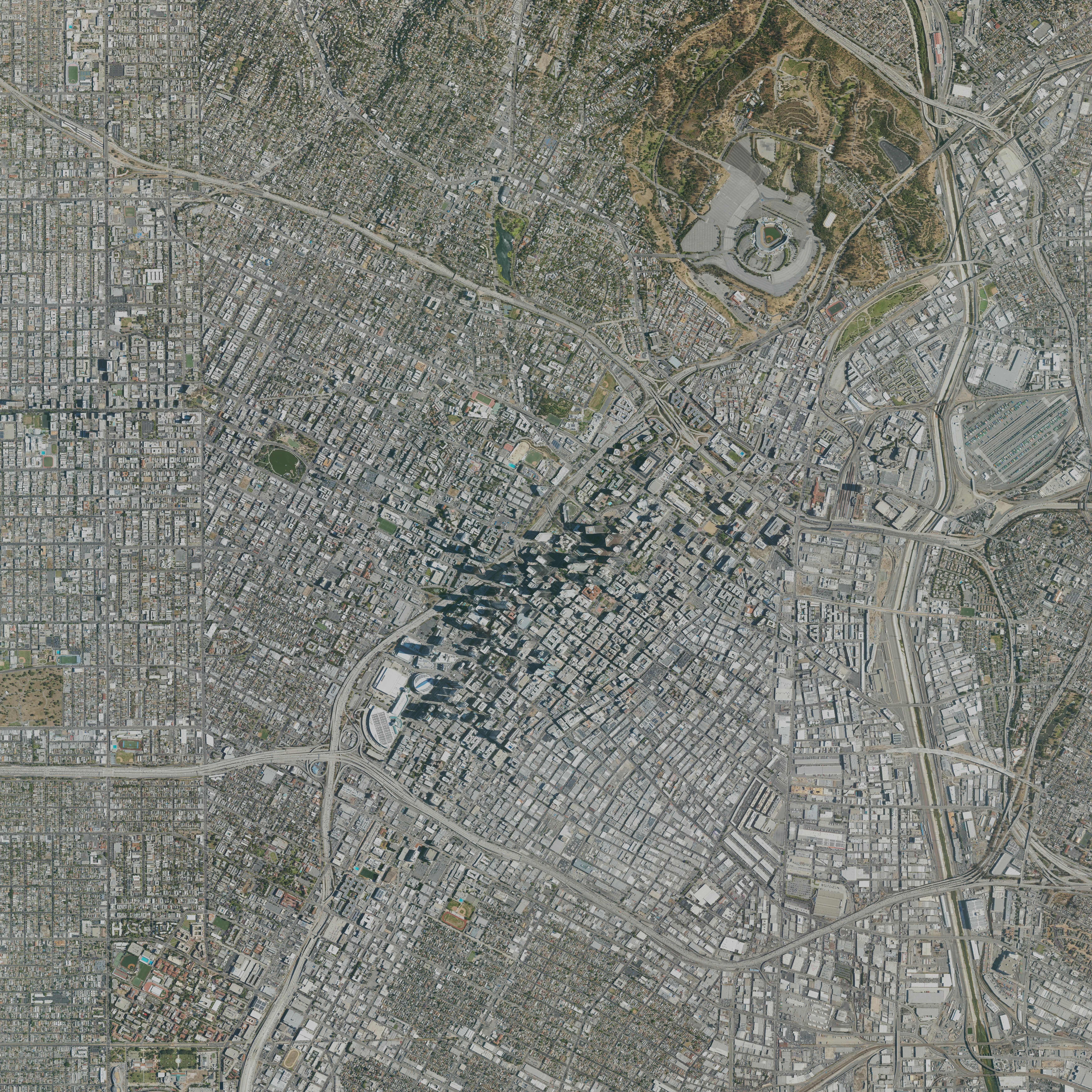 Aerial reference image of central Los Angeles showing downtown, surrounding street grids, freeway interchanges, and Dodger Stadium.