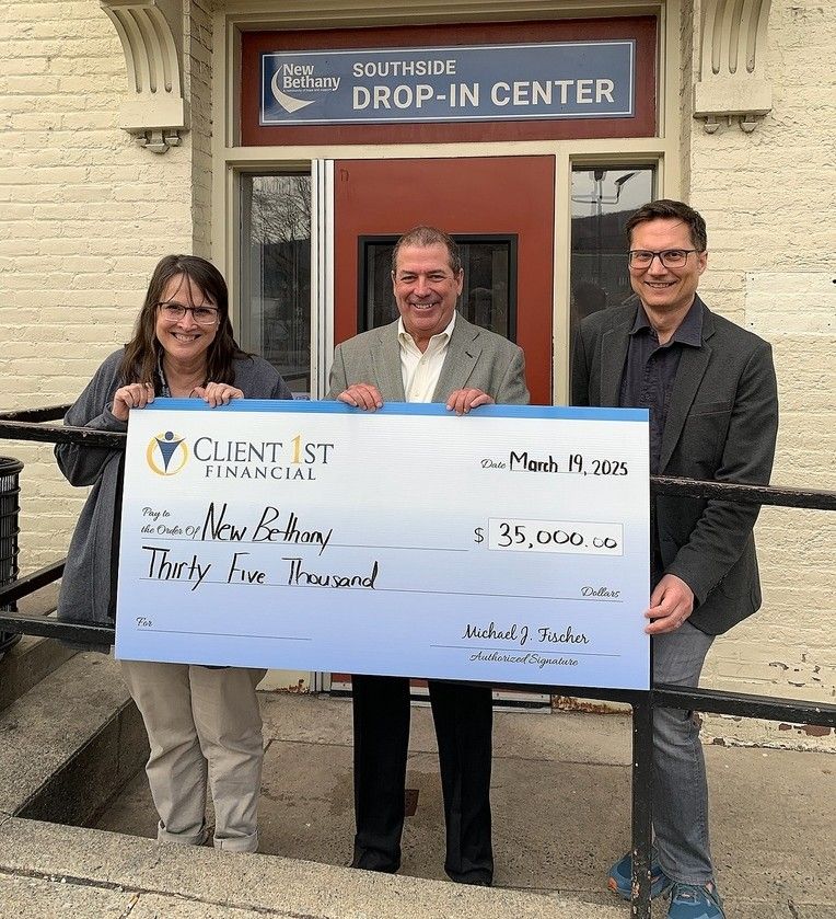 Michael (center) presents a grant from his firm to New Bethany leaders Chris Cassidy, Planning Director and Marc Rittle, Executive Director.