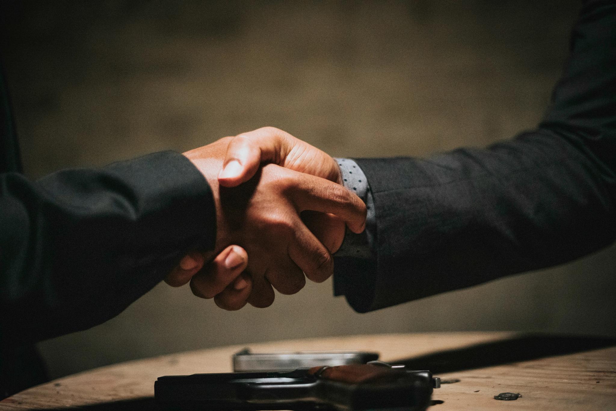 Two professionals shake hands