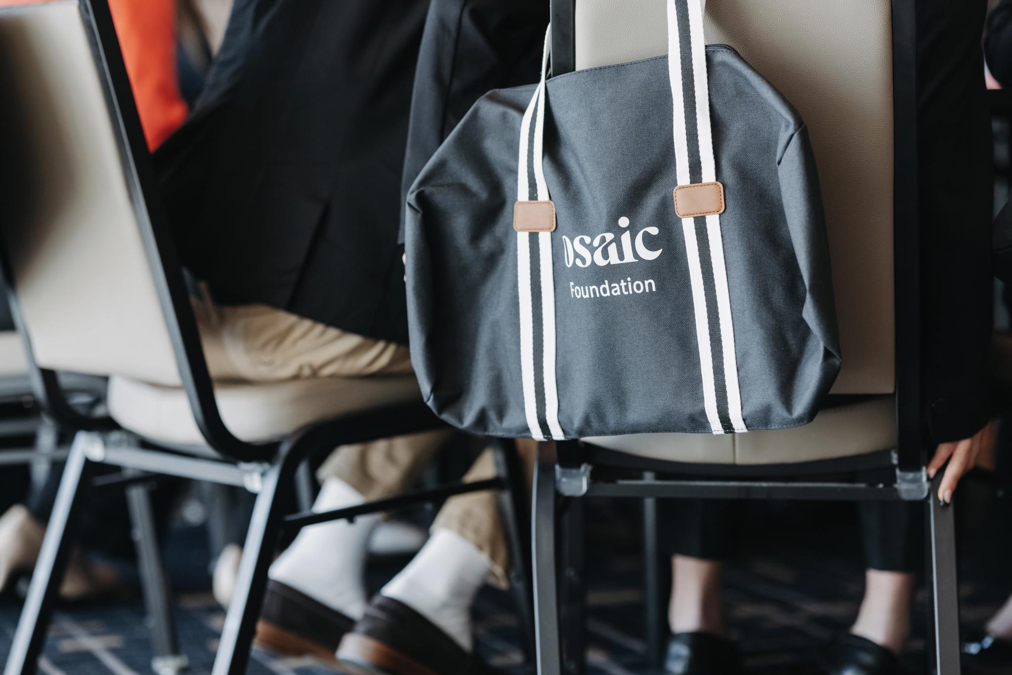 A duffel bag embroidered with the Osaic Foundation logo