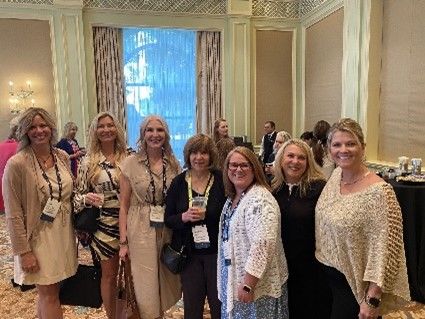 A group of women pose for a photo