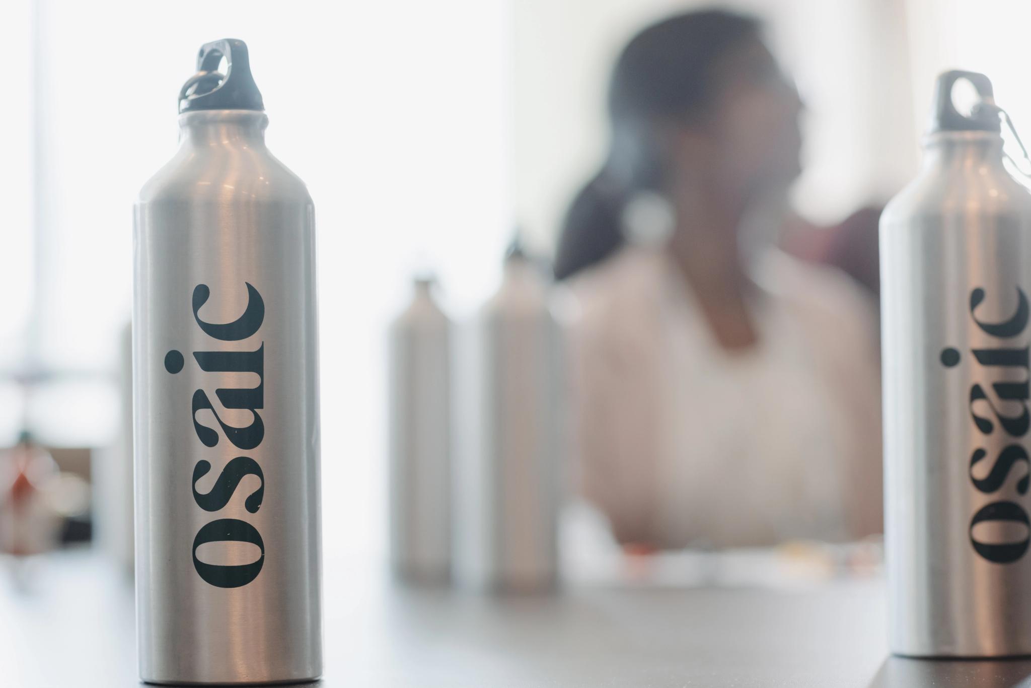 An Osaic tumbler sits on a conference table