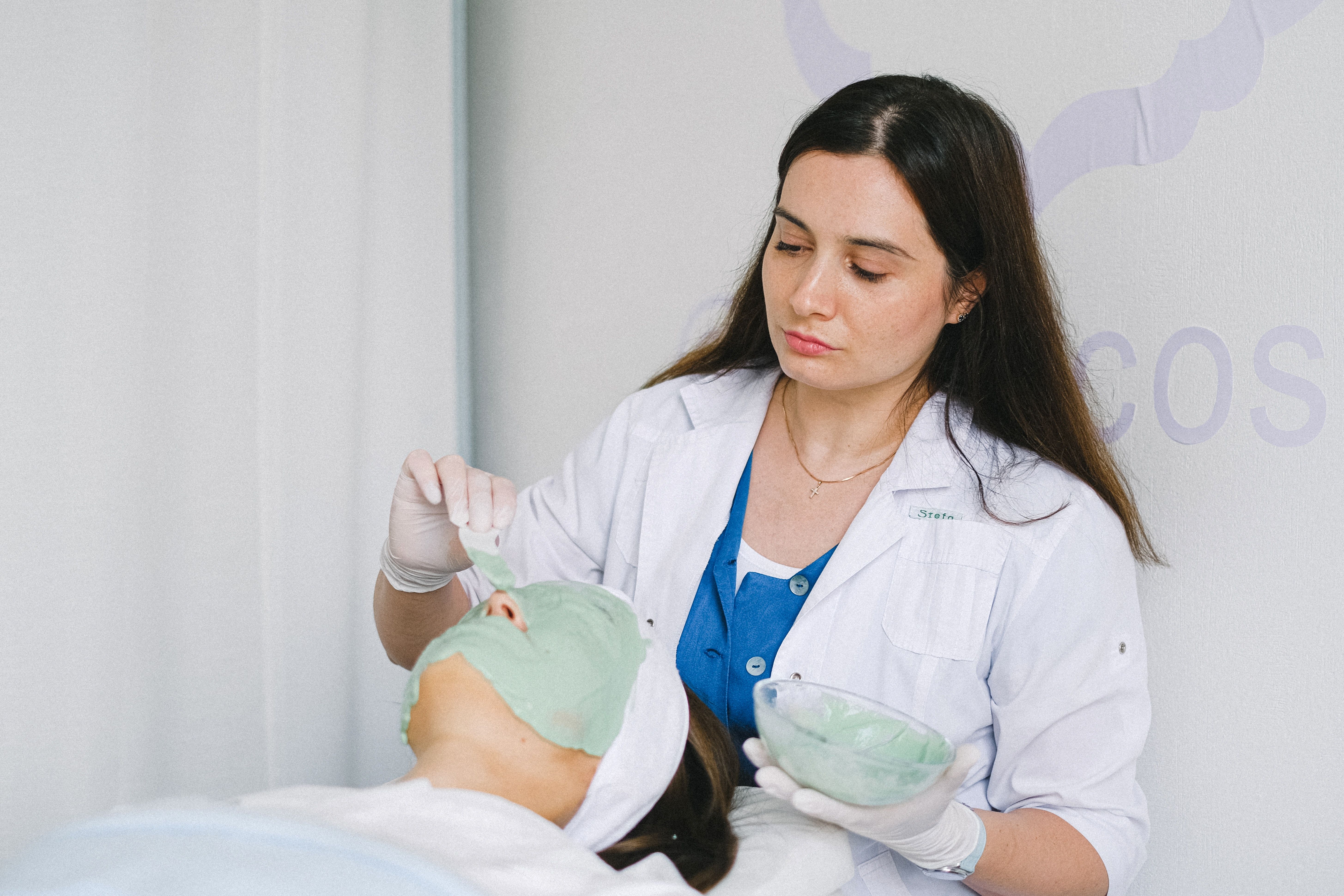 Physician Putting Face Peel on Client 