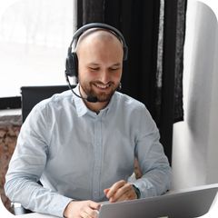 An insurance agent on a headset at a laptop