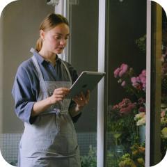 A small business owner looking at a tablet