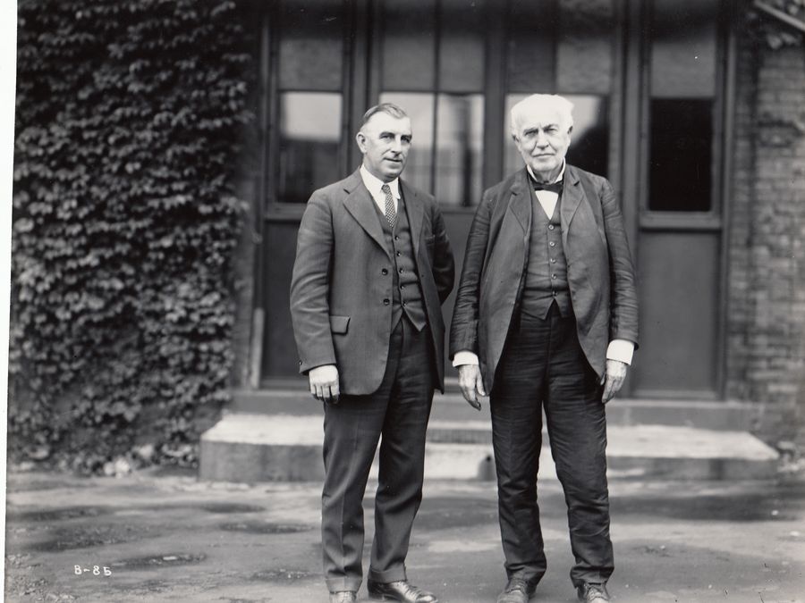 Thomas Edison standing with a visitor in front of Building 5 at his West Orange laboratory.