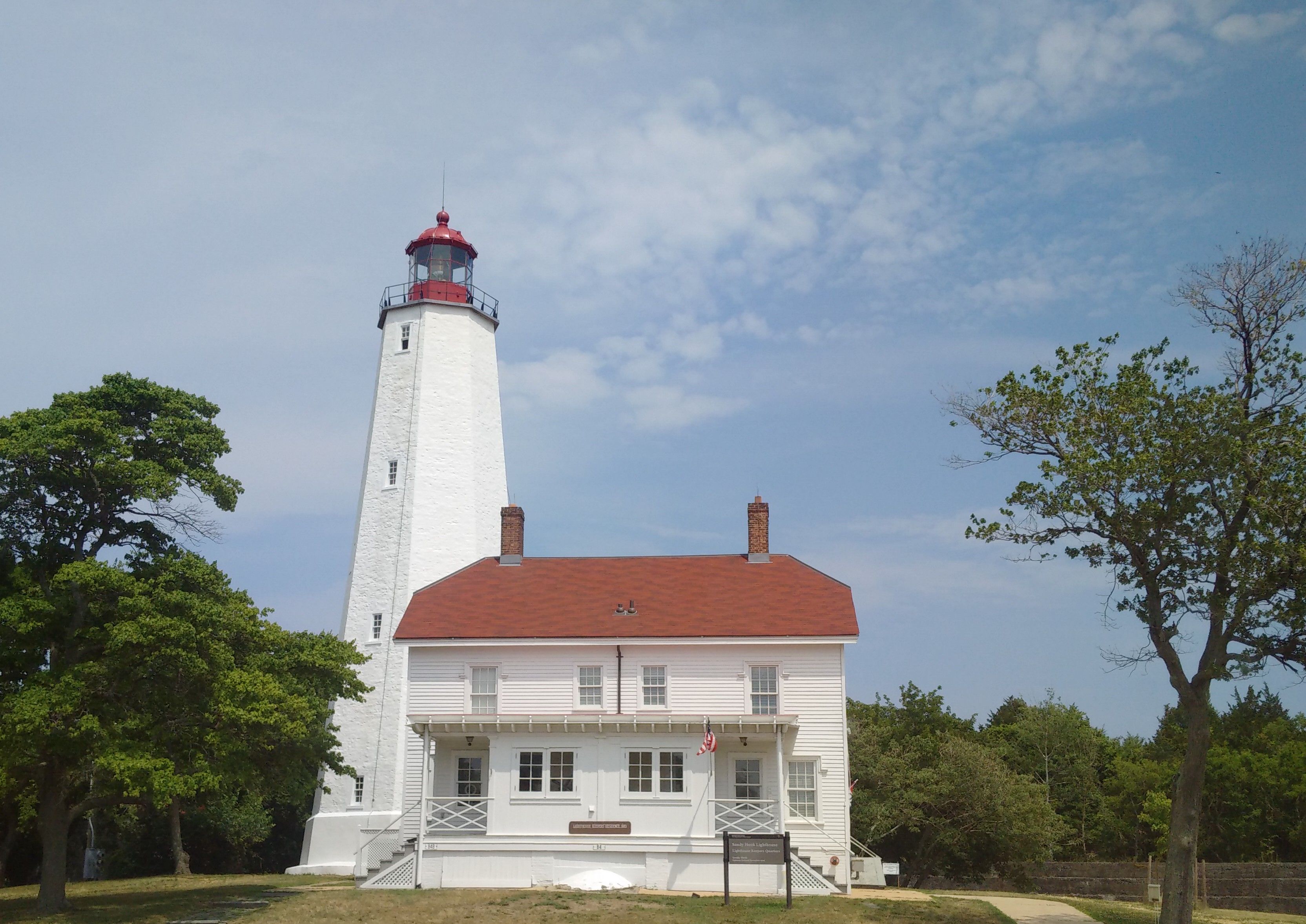 A view of Sandy Hook Lighthouse and its surrounding grounds.