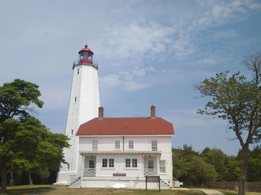 A view of Sandy Hook Lighthouse and its surrounding grounds.