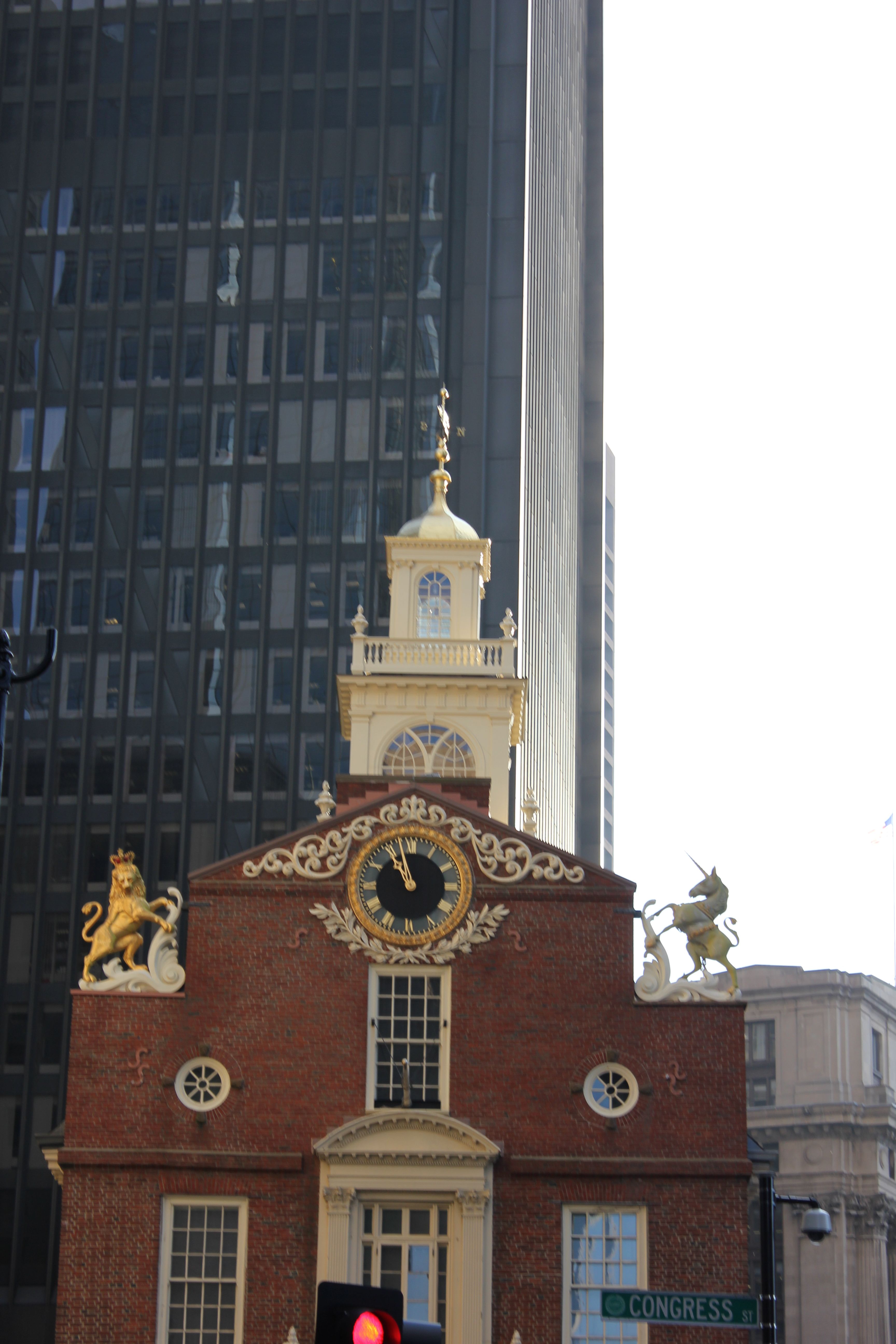 The gilded lion and unicorn, royal symbols, atop the Old State House roof.