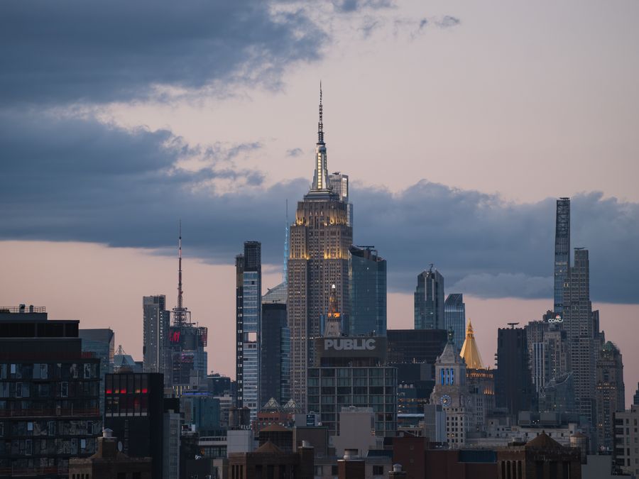 The Empire State Building at dusk, seen from the Brooklyn Bridge.