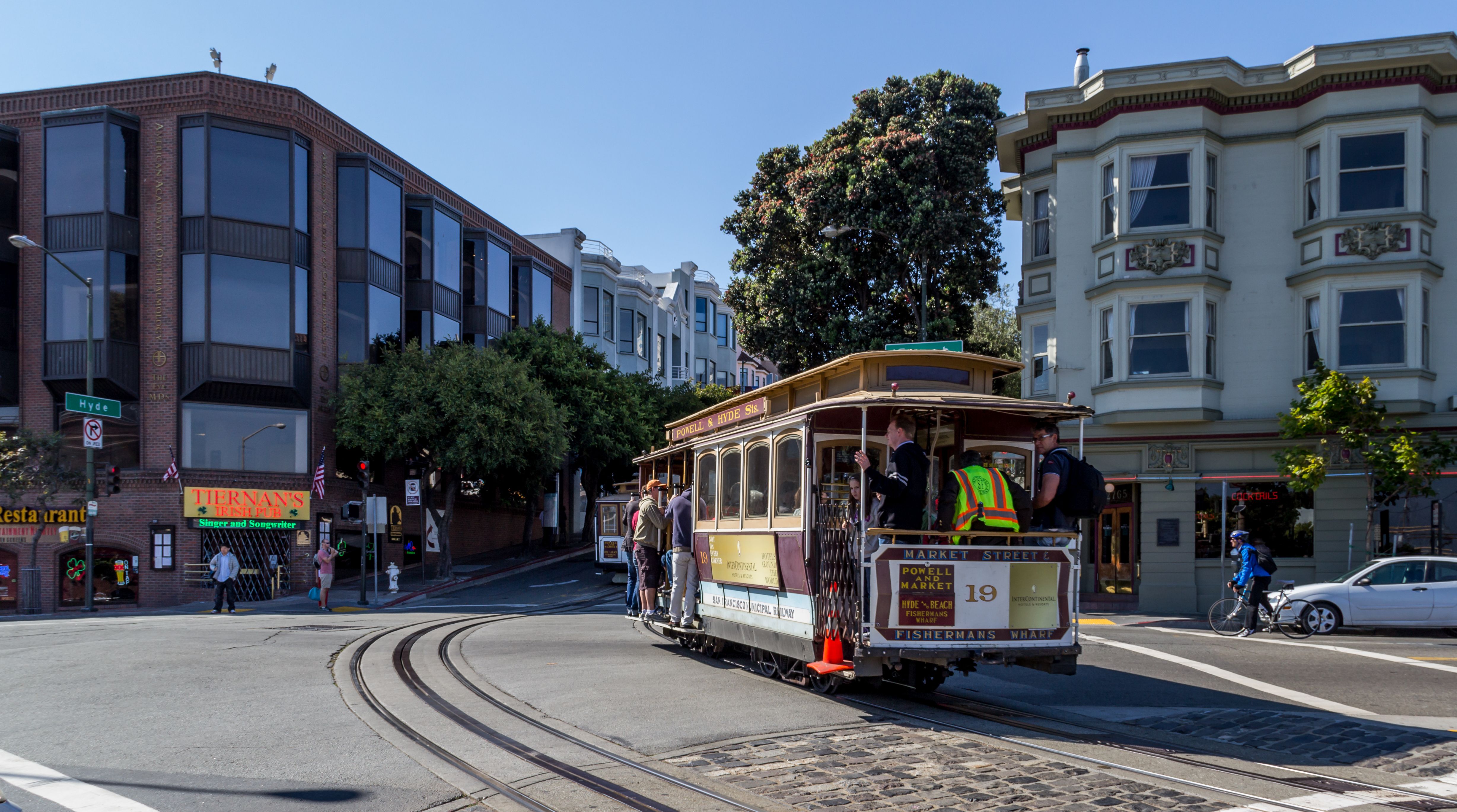 A cable car navigating a San Francisco street.
