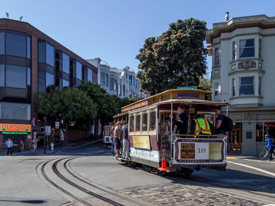 A cable car navigating a San Francisco street.