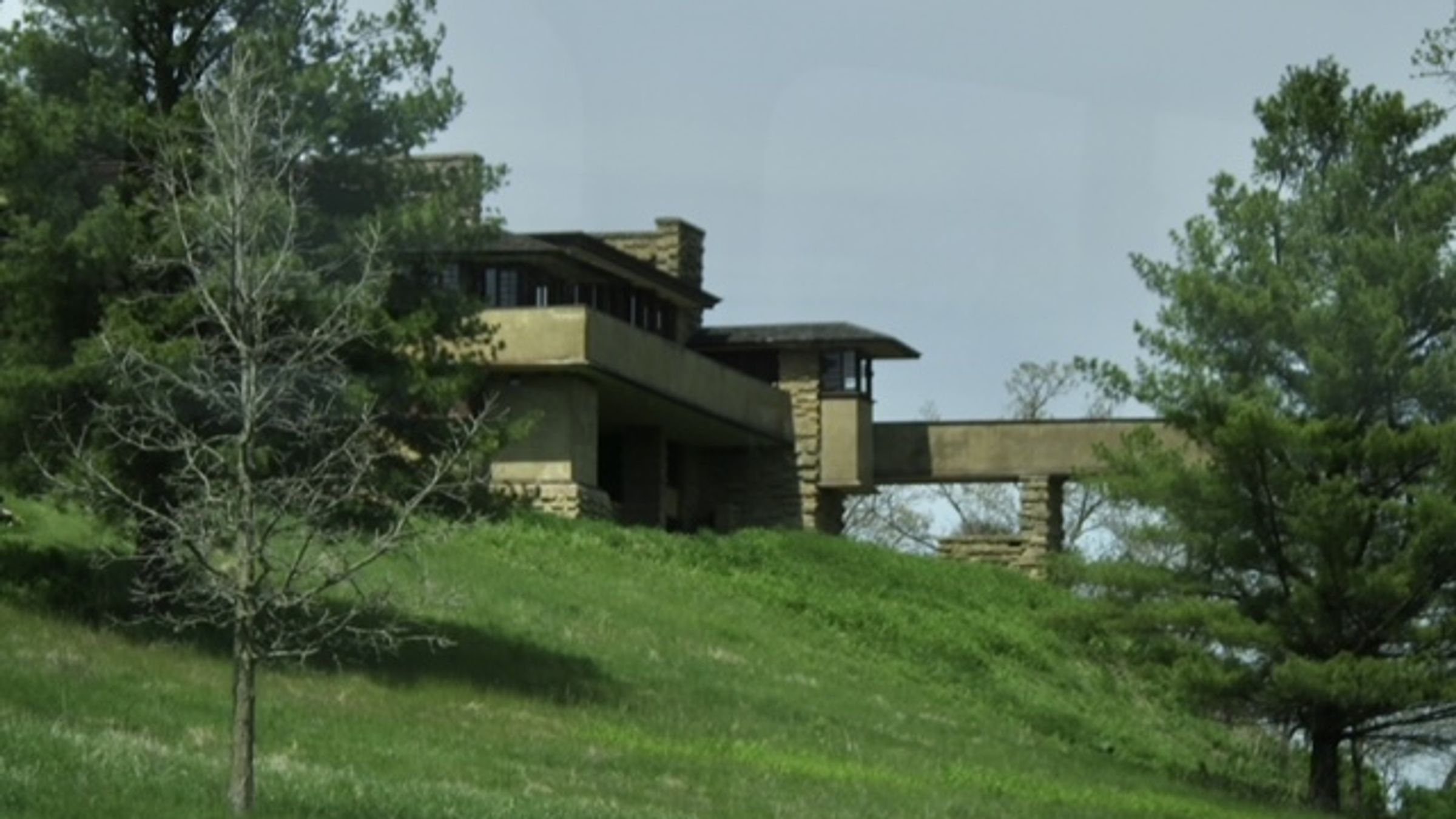 An exterior view of Taliesin, Frank Lloyd Wright's Wisconsin home built into the hillside.