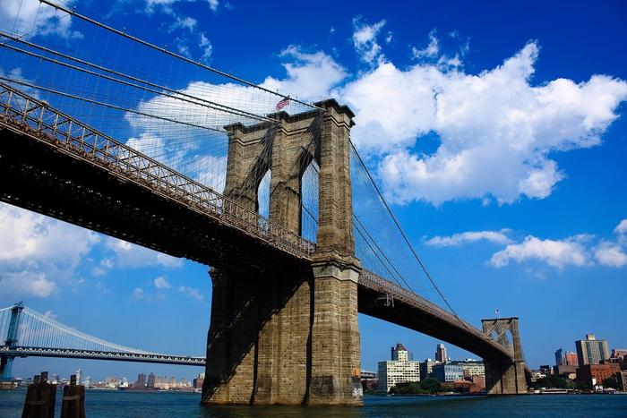 The Brooklyn Bridge with the Manhattan skyline behind it.